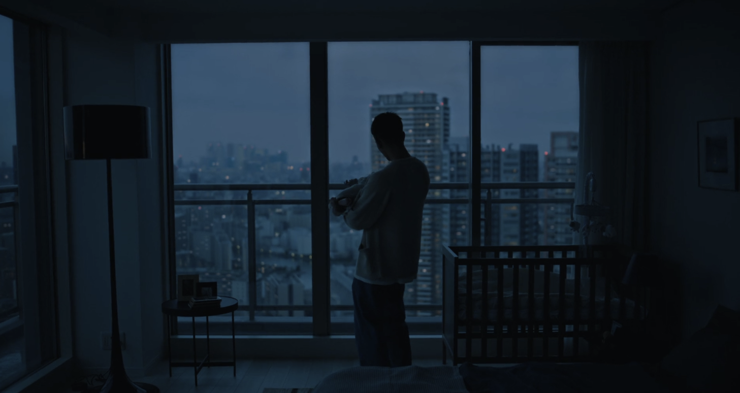 Person by a window at dusk